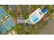 An aerial view highlights the community pool and tennis courts nestled amidst green trees at 2480 Ashbourne Dr, Lawrenceville, GA 30043
