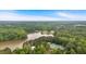 An aerial view of the neighborhood showcases a lake, tennis courts, trees, and swimming pool at 2480 Ashbourne Dr, Lawrenceville, GA 30043