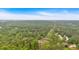 Overhead shot of neighborhood with tree-lined streets and beautiful green landscape at 2480 Ashbourne Dr, Lawrenceville, GA 30043