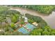 Aerial view features community pool, tennis courts, lake and surrounding landscape at 2480 Ashbourne Dr, Lawrenceville, GA 30043