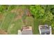 An aerial view of the property showcases lush landscaping, a creek, and a spacious backyard at 2480 Ashbourne Dr, Lawrenceville, GA 30043