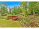 Landscaped backyard with a wooden bridge overlooking a stream at 2480 Ashbourne Dr, Lawrenceville, GA 30043