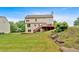 Spacious backyard featuring a wooden deck, steps, and lush green lawn at 2480 Ashbourne Dr, Lawrenceville, GA 30043