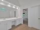 Bathroom with double vanity and doorway to bedroom with ceiling fan at 2480 Ashbourne Dr, Lawrenceville, GA 30043