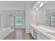 Bathroom with double sinks, tile floor, and tiled shower at 2480 Ashbourne Dr, Lawrenceville, GA 30043