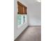 A bedroom with neutral carpet and window with woven shade at 2480 Ashbourne Dr, Lawrenceville, GA 30043