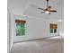 Spacious bedroom features a tray ceiling, plush carpet, and windows overlooking the yard at 2480 Ashbourne Dr, Lawrenceville, GA 30043