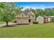 Charming brick home featuring a well-manicured lawn and mature trees in a serene, suburban setting at 2480 Ashbourne Dr, Lawrenceville, GA 30043