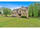 Elegant brick home with well-maintained landscaping, showcasing classic design and curb appeal at 2480 Ashbourne Dr, Lawrenceville, GA 30043