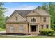 Stately two-story brick home with a symmetrical facade, grand entrance, and manicured front yard at 2480 Ashbourne Dr, Lawrenceville, GA 30043