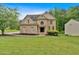 Beautiful brick home with an inviting front lawn, blending elegance and comfort in a neighborhood setting at 2480 Ashbourne Dr, Lawrenceville, GA 30043