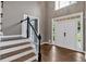 Bright foyer features hardwood floors, staircase, high ceilings and a double front door entrance at 2480 Ashbourne Dr, Lawrenceville, GA 30043
