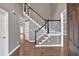 Inviting foyer with hardwood floors, a staircase with dark wood trim, and neutral gray walls at 2480 Ashbourne Dr, Lawrenceville, GA 30043