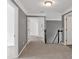Hallway with gray walls and carpet, doorways, and staircase at 2480 Ashbourne Dr, Lawrenceville, GA 30043