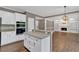 Bright kitchen features white cabinets, stainless appliances, and a breakfast bar overlooking the living room at 2480 Ashbourne Dr, Lawrenceville, GA 30043