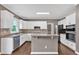 Contemporary kitchen with a center island, stainless steel appliances, and classic white cabinets at 2480 Ashbourne Dr, Lawrenceville, GA 30043