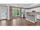 Well-lit eat-in kitchen features an island, stainless appliances, and access to the backyard at 2480 Ashbourne Dr, Lawrenceville, GA 30043