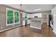 Open eat-in kitchen boasts modern appliances, white cabinets, large windows, and outdoor views at 2480 Ashbourne Dr, Lawrenceville, GA 30043