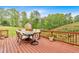 Spacious deck features outdoor dining set and overlooks the serene, wooded backyard at 2480 Ashbourne Dr, Lawrenceville, GA 30043