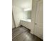 Modern bathroom featuring wood floors and white vanity at 330 Cotton Tail Ln, Villa Rica, GA 30180
