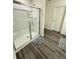 Modern bathroom with glass shower door and wooden floors at 330 Cotton Tail Ln, Villa Rica, GA 30180