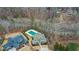 From above, see the neighborhood pool surrounded by trees, offering community recreation and natural beauty at 4960 Shade Creek Xing, Cumming, GA 30028