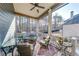 Relaxing screened-in back porch with outdoor seating, ceiling fan, and views of the serene wooded backyard at 4960 Shade Creek Xing, Cumming, GA 30028