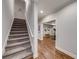 View of carpeted basement staircase leading to finished living space with hardwood flooring at 4960 Shade Creek Xing, Cumming, GA 30028