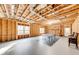 Spacious unfinished basement showing exposed rafters, framing, lighting and ping pong table at 4960 Shade Creek Xing, Cumming, GA 30028
