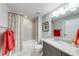 Bathroom featuring a shower-tub combo, gray vanity, granite countertops, and modern fixtures at 4960 Shade Creek Xing, Cumming, GA 30028