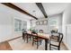 Elegant dining room featuring wood beam ceilings, wainscoting, and an abundance of natural light at 4960 Shade Creek Xing, Cumming, GA 30028