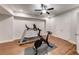 Basement exercise room featuring laminate flooring, ceiling fan, and modern exercise equipment at 4960 Shade Creek Xing, Cumming, GA 30028