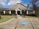 Community clubhouse with manicured lawn and accessible parking on a beautiful day at 4960 Shade Creek Xing, Cumming, GA 30028