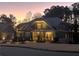 Exterior of a beautiful two-story home at twilight with subtle landscape lighting at 4960 Shade Creek Xing, Cumming, GA 30028