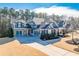 Beautiful two-story home with a three-car garage and a well-manicured lawn at 4960 Shade Creek Xing, Cumming, GA 30028