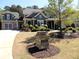 Charming two-story home with a manicured lawn, detailed trim, and a stone address marker at 4960 Shade Creek Xing, Cumming, GA 30028