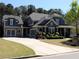 Charming two-story home featuring a spacious driveway, detailed trim, and manicured landscaping at 4960 Shade Creek Xing, Cumming, GA 30028