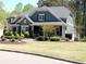 Inviting two-story home features a well-manicured lawn and charming front porch at 4960 Shade Creek Xing, Cumming, GA 30028