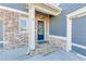 Charming home entrance with a brick facade, stone steps, and a welcoming blue front door at 4960 Shade Creek Xing, Cumming, GA 30028