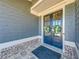 Stylish double front doors with decorative wreaths, set against a backdrop of gray siding and stone flooring at 4960 Shade Creek Xing, Cumming, GA 30028