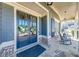 Inviting front porch with double doors, complemented by rocking chairs and stylish exterior details at 4960 Shade Creek Xing, Cumming, GA 30028