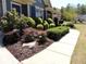 Beautifully landscaped front yard with lush bushes and a well-maintained walkway at 4960 Shade Creek Xing, Cumming, GA 30028