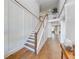 Elegant hallway with high ceilings, decorative wood trim, and a staircase leading to an upper level at 4960 Shade Creek Xing, Cumming, GA 30028