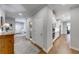 Open-concept hallway featuring a laundry room, staircase and a kitchen in the distance at 4960 Shade Creek Xing, Cumming, GA 30028