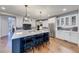 Spacious kitchen featuring a large island with seating, stainless steel appliances, and hardwood flooring at 4960 Shade Creek Xing, Cumming, GA 30028