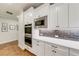 Well-appointed kitchen with stainless steel appliances, custom white cabinets and a microwave oven at 4960 Shade Creek Xing, Cumming, GA 30028