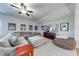 Comfortable living room featuring a large sectional sofa, ceiling fan and a wall-mounted television at 4960 Shade Creek Xing, Cumming, GA 30028