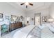 Comfortable primary bedroom featuring tray ceilings, soft carpet, and a large window overlooking the backyard at 4960 Shade Creek Xing, Cumming, GA 30028