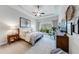 Inviting primary bedroom with tray ceilings, plush carpet, and serene views of the wooded backyard at 4960 Shade Creek Xing, Cumming, GA 30028