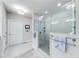 Modern bathroom shower with glass door, tiled walls, and updated fixtures for a spa-like experience at 4960 Shade Creek Xing, Cumming, GA 30028